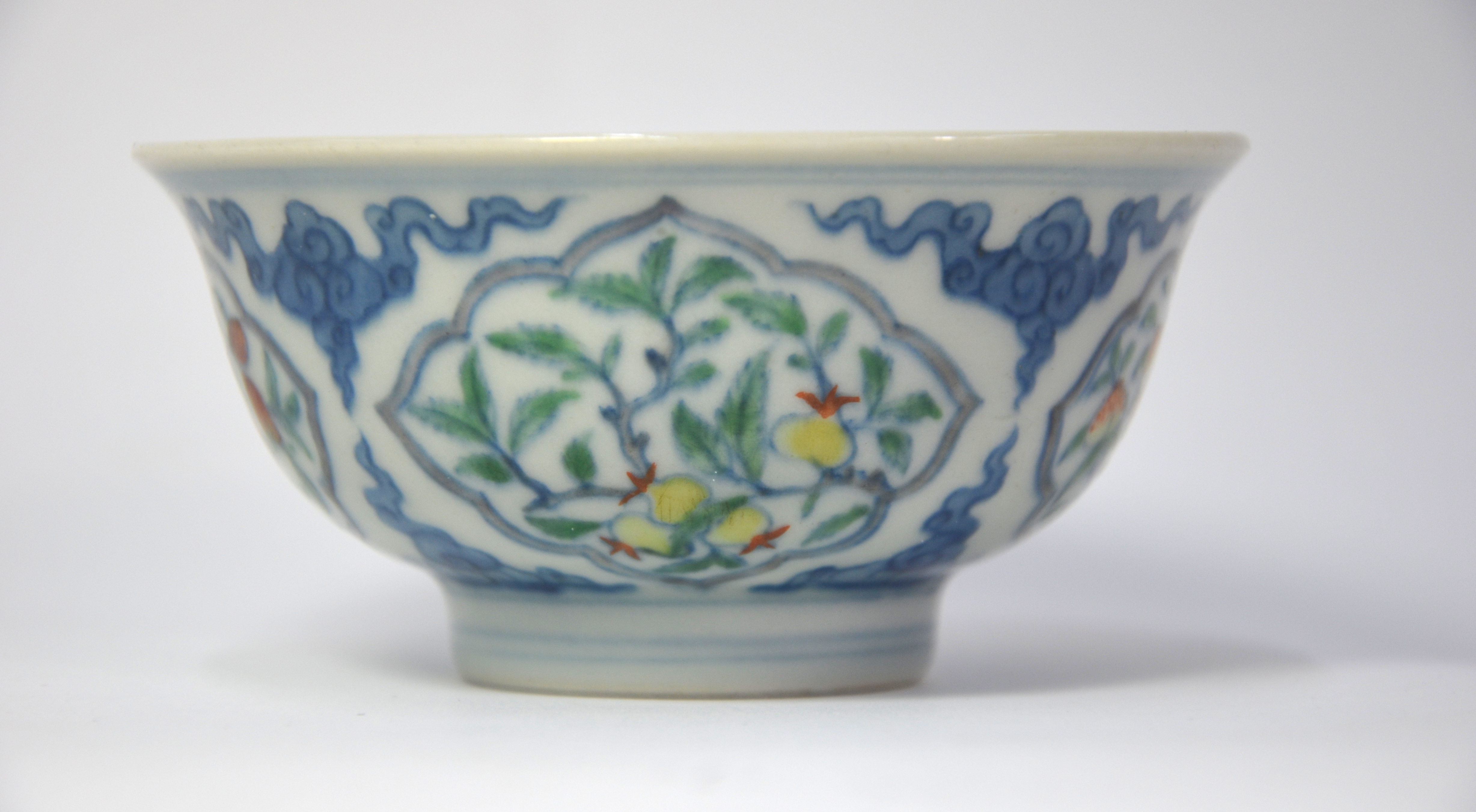 A Doucai bowl, decorated with underglaze blue cloud scrolls dividing four shaped panels of various - Image 4 of 6