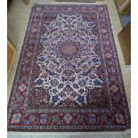 A fine Persian Nian small carpet, the flowering vine design centred by a sunburst medallion, on