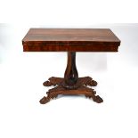A Regency rosewood fold over card table with unusual shaped tri-form support to a quad platform