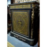 An ormolu mounted and brass inlaid ebonised cabinet with slate top, the door with allegorical scene,