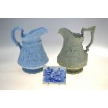 Two Victorian Ridgway relief moulded jugs, one blue ground decorated with a tavern scene and a