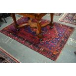 An old Persian rug, dark blue ground, 198 x 128 cm