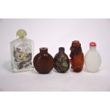 Five Chinese snuff bottles, including: a cloisonne enamel bottle decorated with floral designs; an