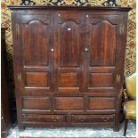 A substantial late 17th / early 18th century joint oak livery cupboard, having arched panel doors