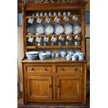 A Victorian scumbled pine dresser, the single piece structure with plank backed open rack over two