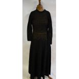 A 1970s black crocheted cotton full-length dress with narrow crocheted belt, made by Rose Lewis of