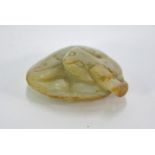 A mottled green jade carving of a coiled cat, curled up on a leaf, 5.5 cm long; post Qing Dynasty