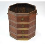 An antique brass bound mahogany bucket of octagonal form with lion mask adornment and brass  handles