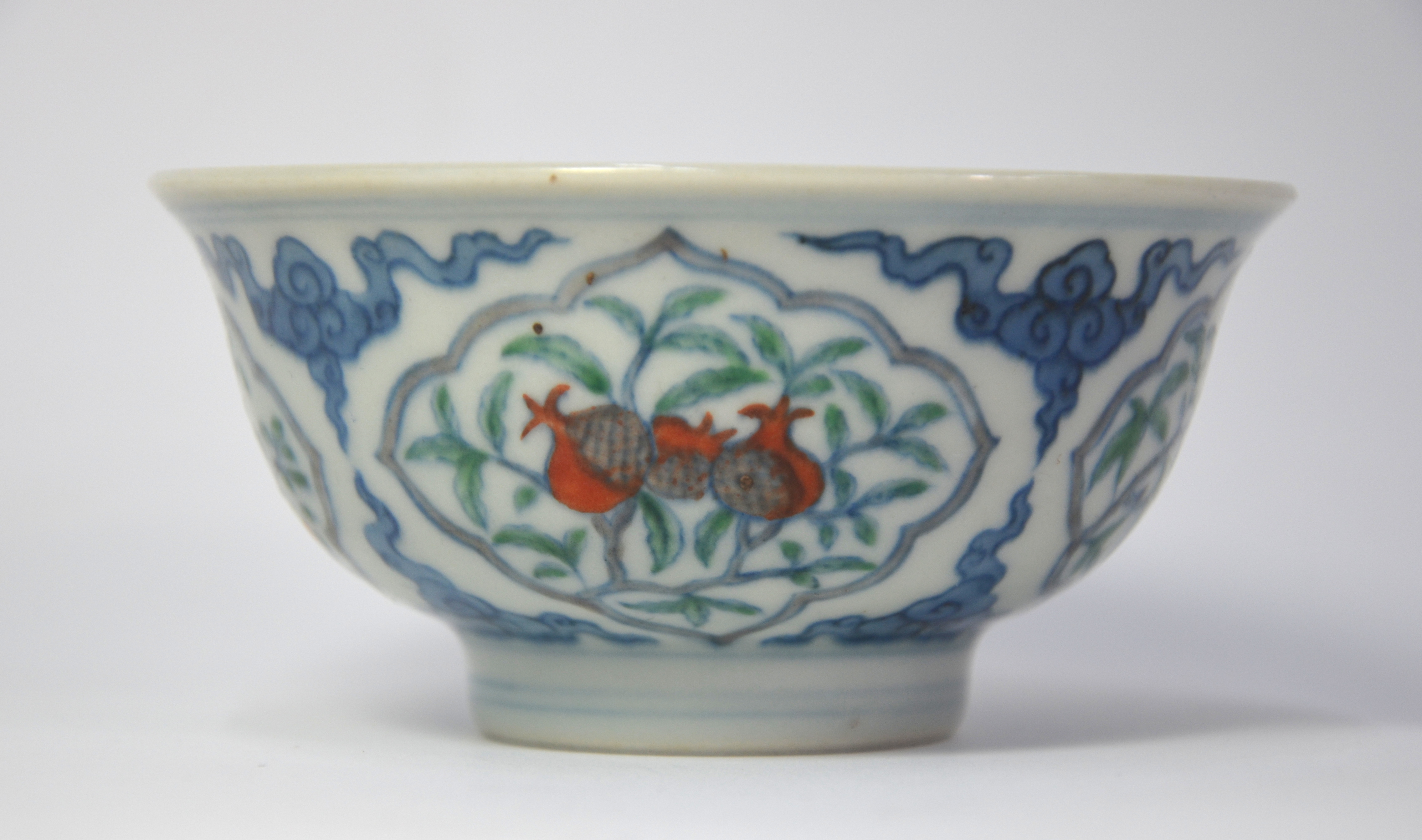 A Doucai bowl, decorated with underglaze blue cloud scrolls dividing four shaped panels of various - Image 2 of 6