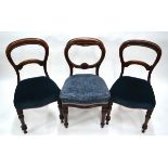 A pair of Victorian mahogany dining side chairs with overstuffed serpentine seats, to/w another