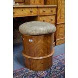 A Victorian satin-birch drum commode, the overstuffed hinged seat enclosing a fitted pottery commode