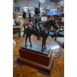 A Horse Artillery officer on horseback, bronzed metal-resin, raised on a mahogany plinth base, 43 cm