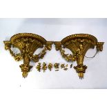 A good pair of Regency giltwood and composite wall brackets, mounted with rams heads flanking the