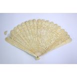 A Cantonese ivory fan with 19 sticks; decorated with typical designs of figures, gardens and