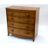 A 19th century Georgian mahogany bow-front chest of four long drawers, with turned wooden pulls,