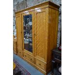 Heal & Son, London, a Victorian satin-birch triple wardrobe/compactum, the centre door with mirrored