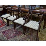 A set of seven Victorian framed sabre leg dining chairs with drop-in seat pads, comprising a pair of