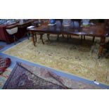 A handmade Lahore carpet, muted cream, brown, greens, stylised foral design, 358 x 264 cm [10525/