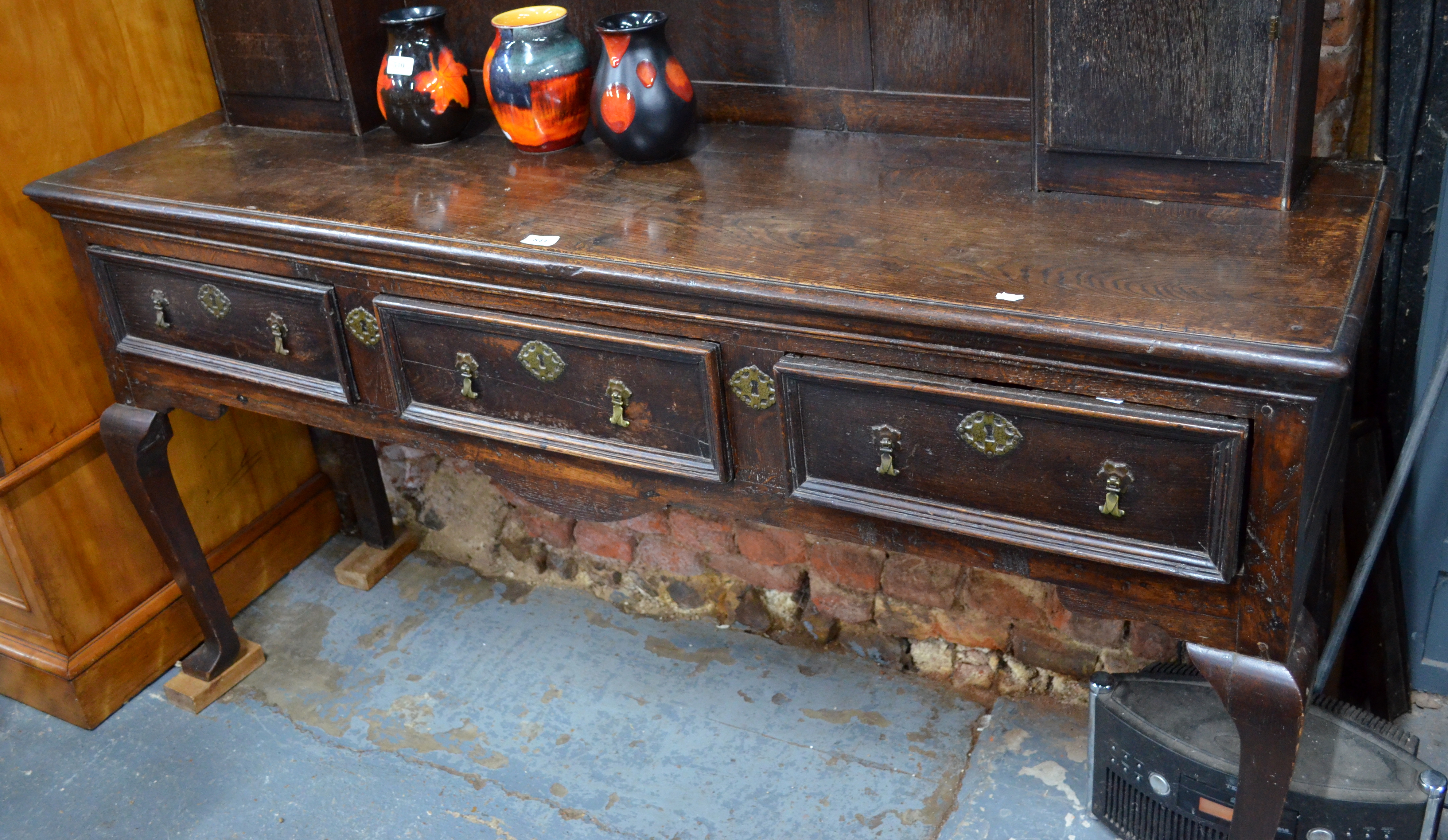 An 18th century and later oak high dresser, the dentil moulded cornice over plank backed open - Image 2 of 3