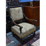 A pair of antique oversize 17th century style oak framed open armchairs with overstuffed seats (2)