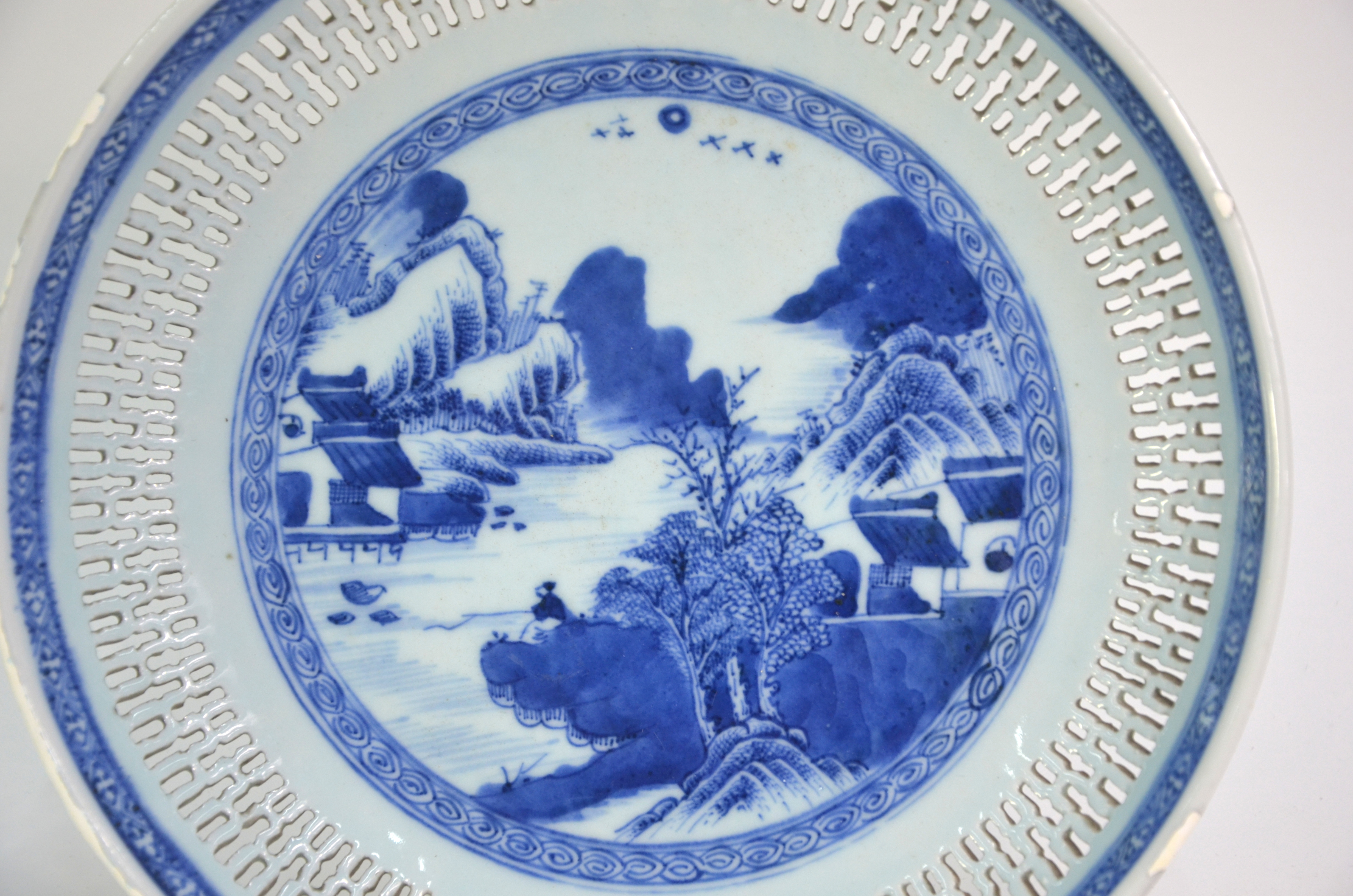 A blue and white dish of circular form with reticulated rim; decorated with a fisherman in a - Image 3 of 6