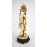 A stained ivory okimono, carved as a standing festival entertainer (or other character), wearing