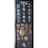 A framed selection of Military cap badges, lapel badges, buttons, etc., including Hussars,