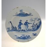 An 18th/19th century Delft blue and white plate decorated with two Chinese figures conversing on a