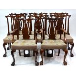 A set of eight Georgian style mahogany ear back dining chairs with pierced vase shaped vertical