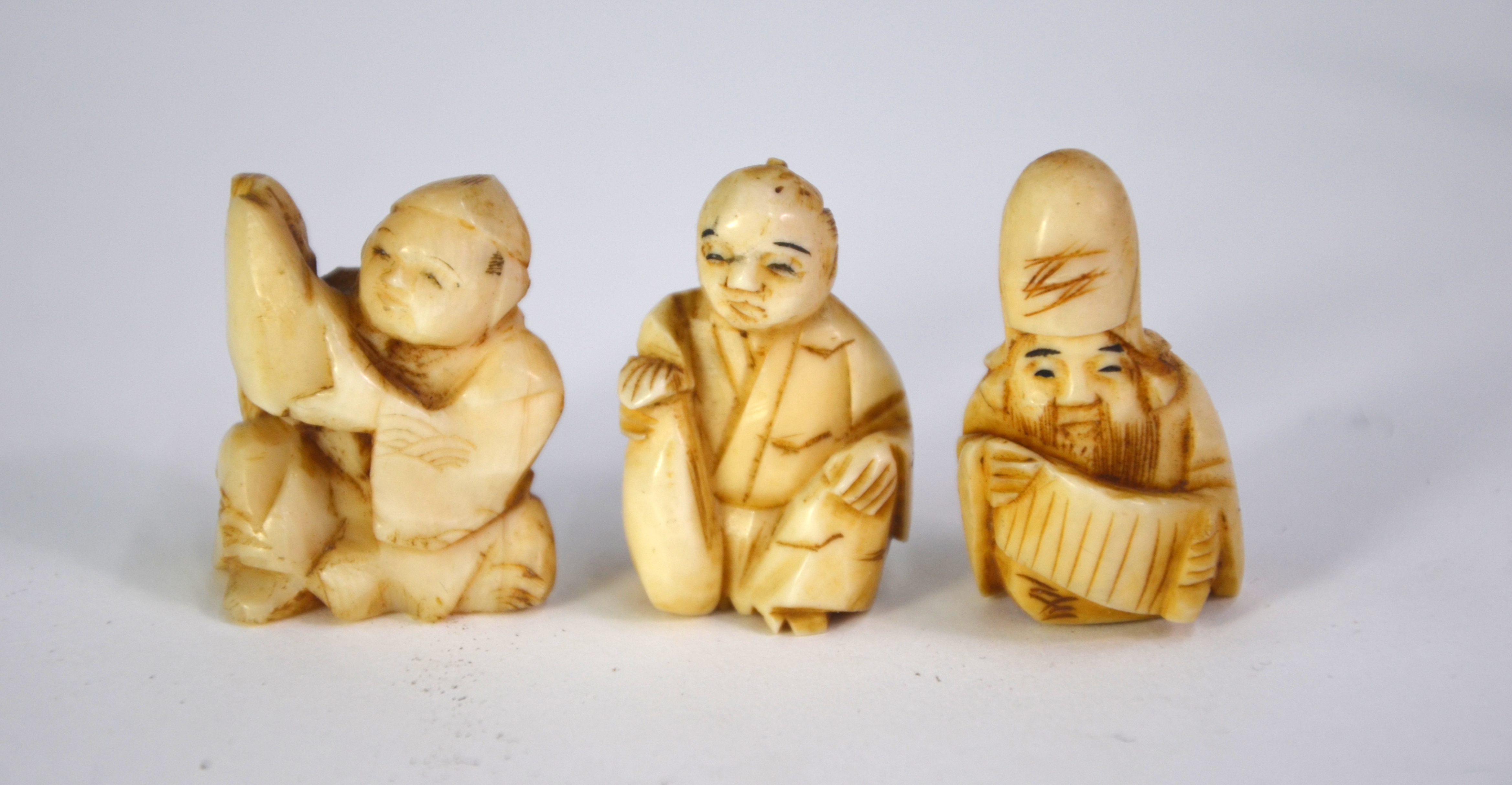 Seven ivory netsuke, including: one of Jurojin holding a makemono; and one of Gama Sennin holding - Image 2 of 9