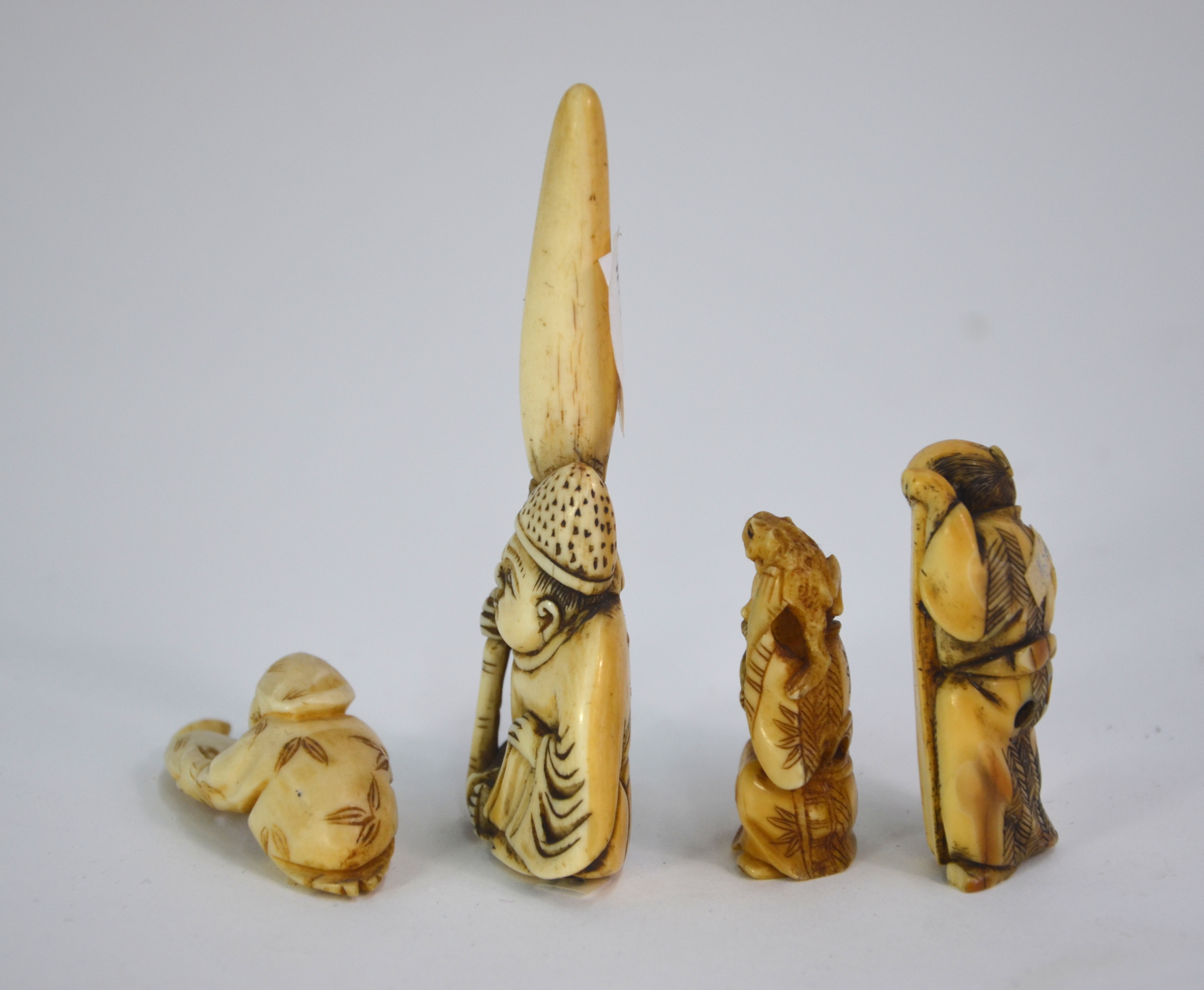Seven ivory netsuke, including: one of Jurojin holding a makemono; and one of Gama Sennin holding - Image 7 of 9