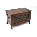 An Arts & Crafts period walnut small coffer/trunk, of jointed construction with relief decorated