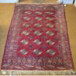 A Turkoman rug, last quarter 20th century, three rows of guls on red-brown ground, 130 x 95 cm