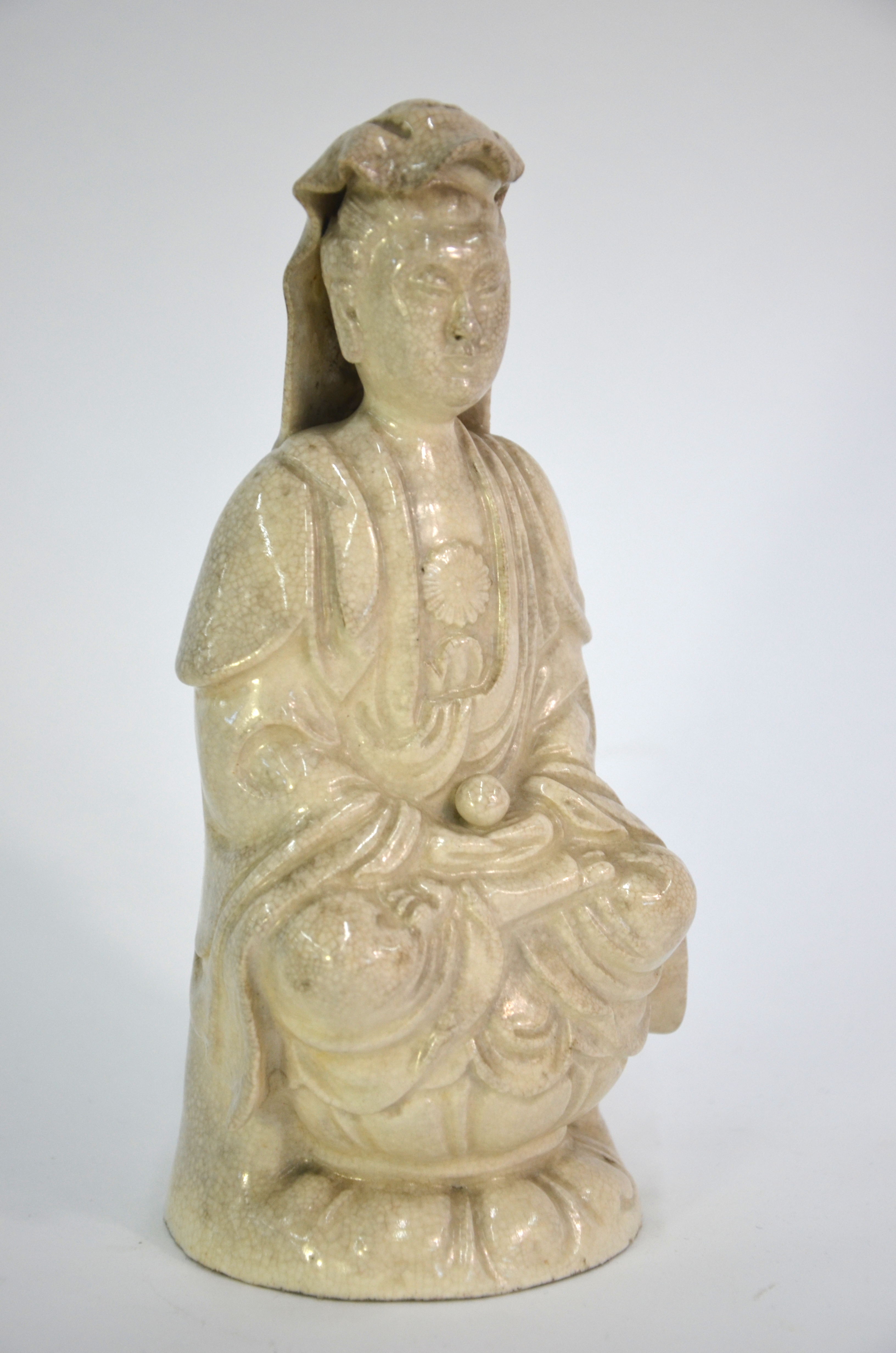 A blanc-de-chine style figure of Guanyin, the Bodhisattva of Mercy; seated in dhyanasana on a