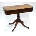 A Regency mahogany card table, the fold over top with baize lining over a storage well and frieze