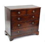 A 19th century mahogany chest of two short over three long graduated drawrs, raised on shaped