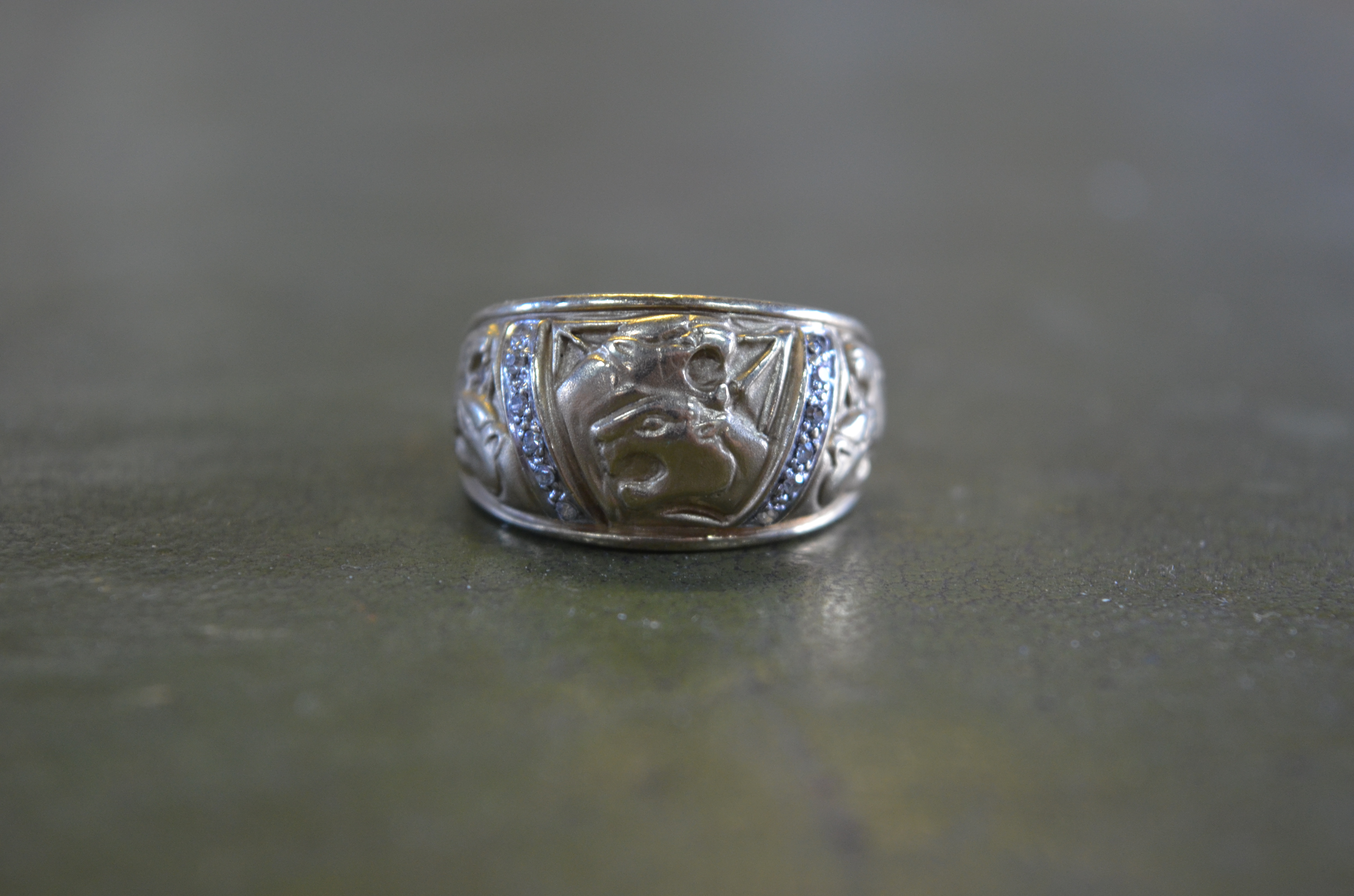 A 9ct gold ring set with small diamonds flanked by incised snarling tiger's heads to/w a brass - Image 3 of 8