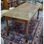 A 19th century French fruit wood table, the cleated plank top over a frieze drawer to one end and