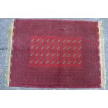 An Afghan Turkoman design rug, the four rows of guls on mid red ground, 220 x 159 cm