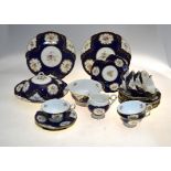Coalport tea service, blue scale ground decorated with gilt edged floral reserves, pattern x3449/