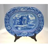 An early 19th century blue transfer printed pearlware meat plate with gravy well decorated with