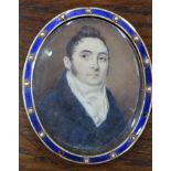 An oval portrait miniature on ivory of a young Regency gentleman with blue coat and high