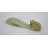 A mottled jade belt hook with mythological animal head and oval boss; 8.5 cm long, Qing Dynasty or