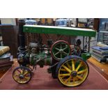 A large live steam model traction engine, c/w accessories and driver 48 x 65 cm (no boiler