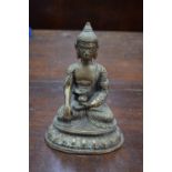 A gilt metal figure of the Mahayana Buddhist Deity, Amitabha, seated on a lotus base in dhyanasana