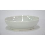 A small white monochrome dish of circular form; 9 cm diameter, underglaze blue Qianlong six-