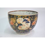 A Japanese Imari deep bowl, decorated in underglaze blue, orange and other enamels with panels