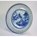 A blue and white dish of circular form with reticulated rim; decorated with a fisherman in a