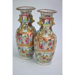 A pair of Canton famille rose vases; each one decorated with panels depicting Manchu/Chinese