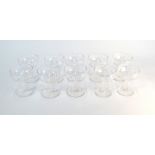 A set of ten champagne saucers having hexagonal faceted hollow stems, flat foot and ground out